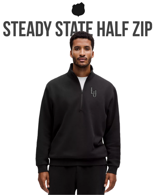 Man wearing a black 'Steady State Half Zip' pullover with a logo on a white background